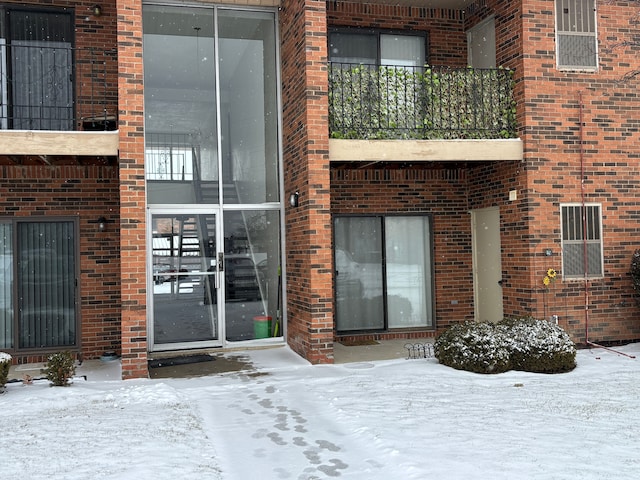 view of snow covered property entrance