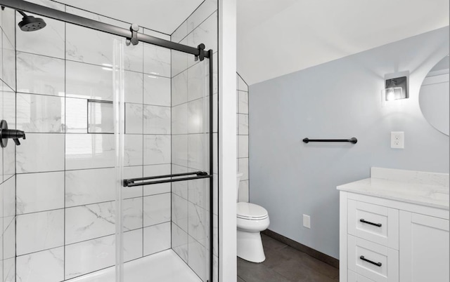 bathroom featuring toilet, an enclosed shower, and vanity