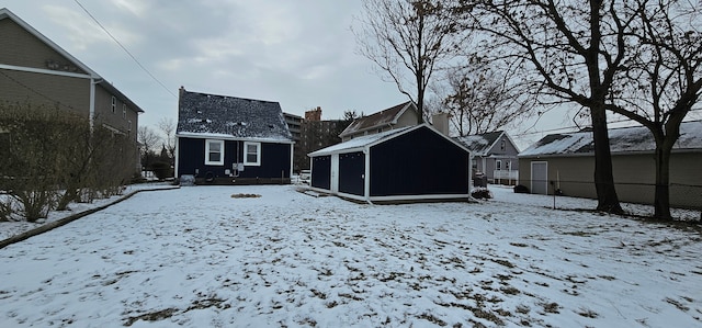 view of snow covered back of property