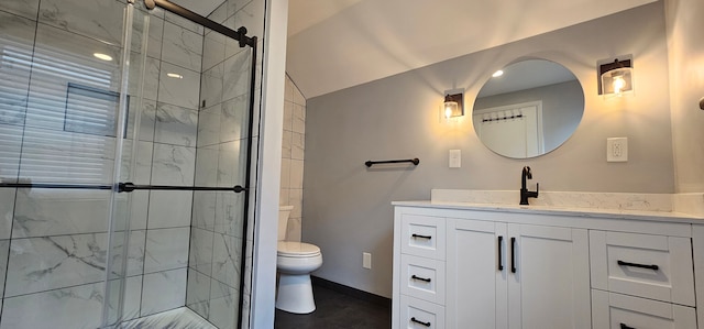 bathroom with vanity, toilet, vaulted ceiling, and an enclosed shower