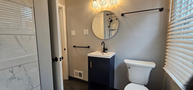 bathroom with vanity and toilet