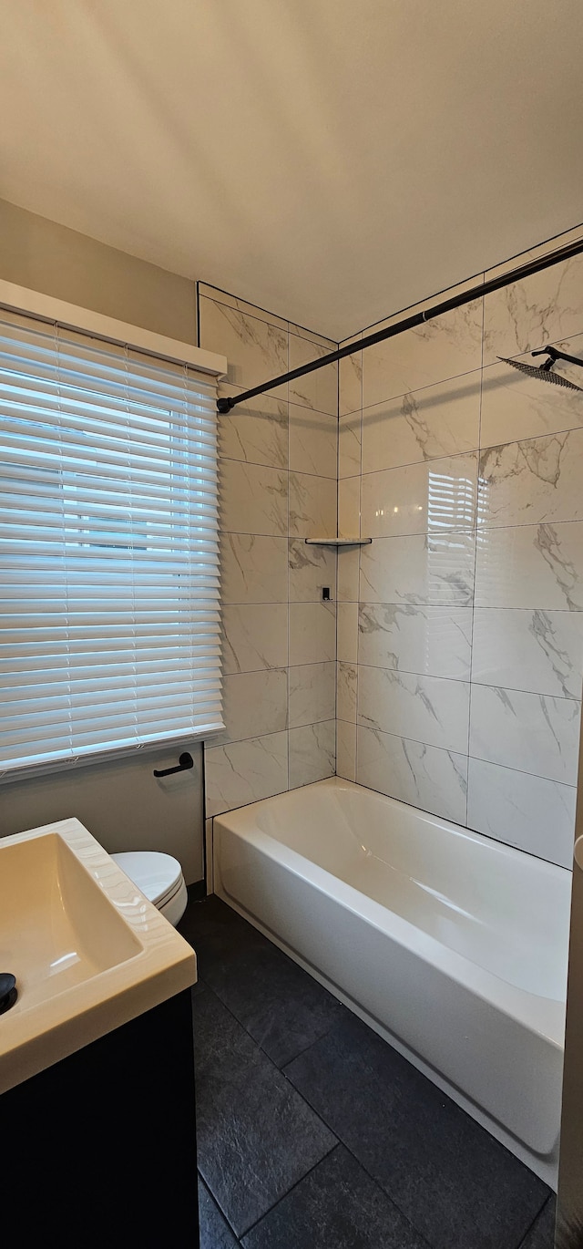 full bathroom with vanity, toilet, and tiled shower / bath combo