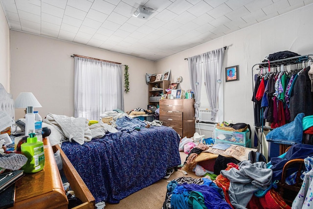 carpeted bedroom featuring multiple windows