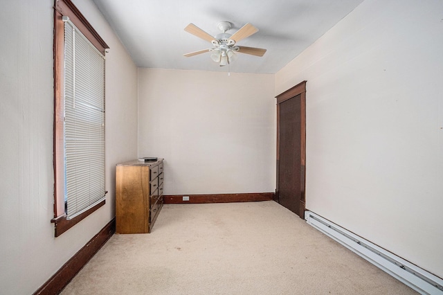 unfurnished room featuring ceiling fan, baseboard heating, and light carpet