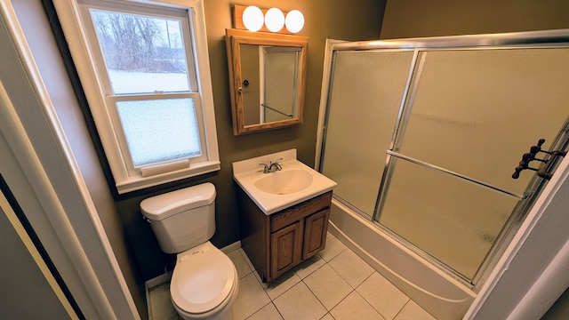 full bathroom with tile patterned floors, toilet, vanity, and shower / bath combination with glass door