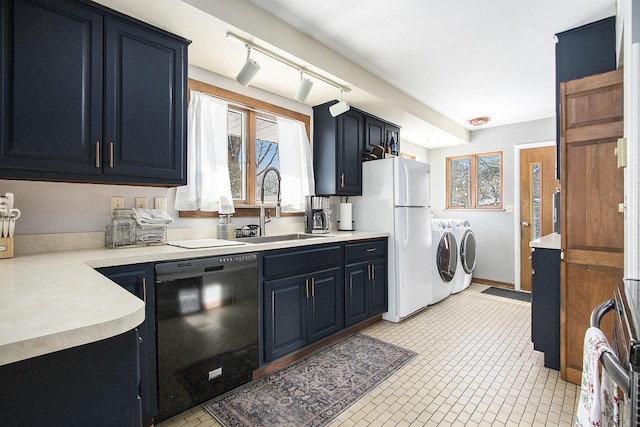 kitchen with separate washer and dryer, black dishwasher, white fridge, sink, and blue cabinets