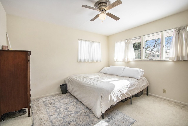 bedroom with ceiling fan and light carpet