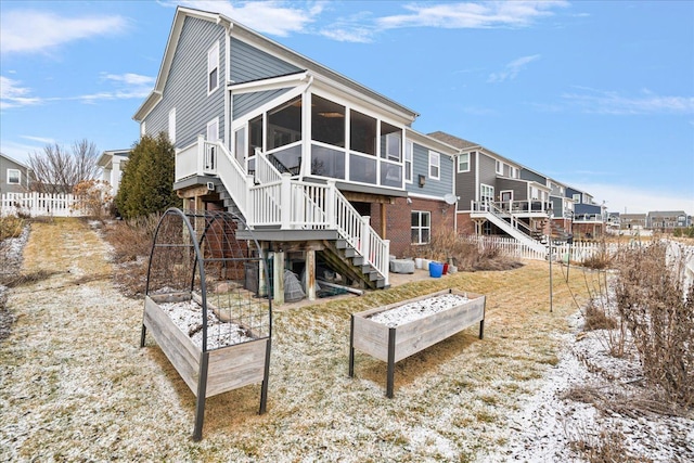 back of house featuring a sunroom