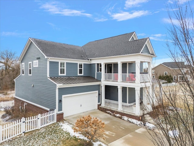 view of front of property with a garage and a balcony