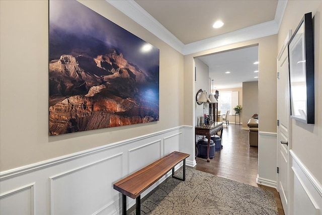 hallway with hardwood / wood-style flooring and crown molding