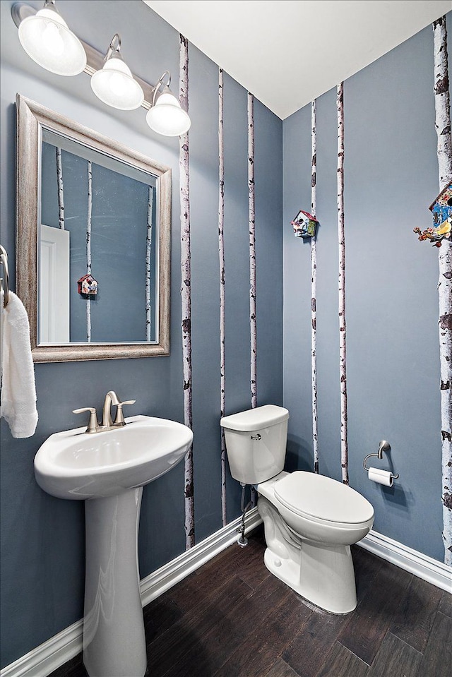 bathroom with hardwood / wood-style floors and toilet