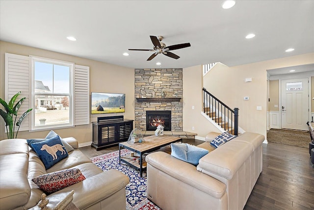 living room with hardwood / wood-style floors, a fireplace, and ceiling fan