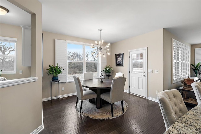 dining area featuring plenty of natural light, a notable chandelier, and dark hardwood / wood-style flooring