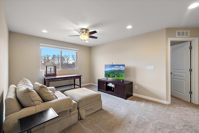 carpeted living room with ceiling fan