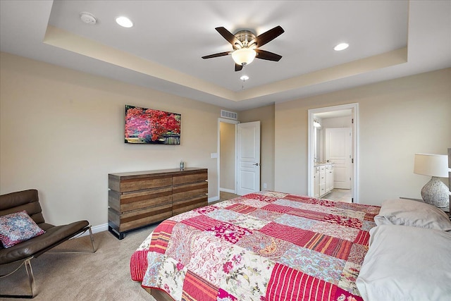 bedroom with light carpet, a raised ceiling, and ceiling fan