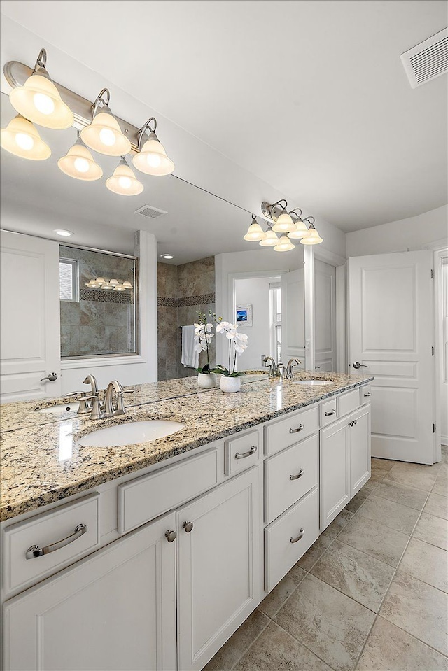 bathroom with vanity and a shower with shower door