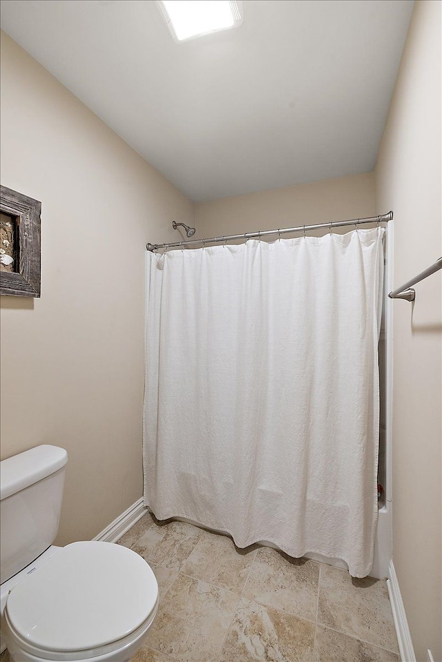 bathroom with shower / bath combo and toilet