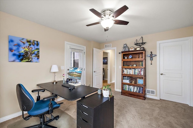 carpeted office space with ceiling fan