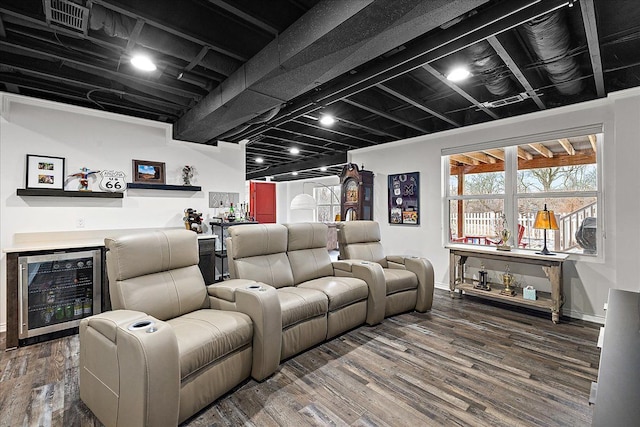 home theater with hardwood / wood-style flooring, beverage cooler, and indoor bar