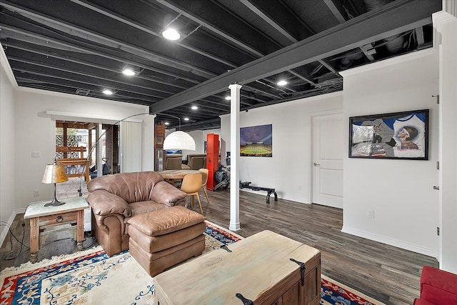 living room featuring dark hardwood / wood-style flooring and decorative columns