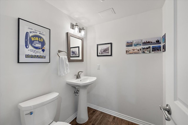 bathroom featuring hardwood / wood-style flooring, sink, and toilet