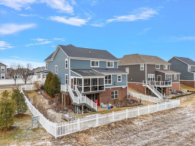 back of house featuring a sunroom and a deck