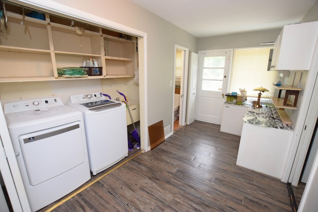 laundry room featuring dark wood-type flooring and washing machine and clothes dryer