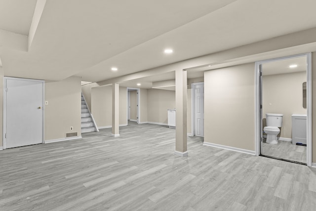 basement with light hardwood / wood-style floors