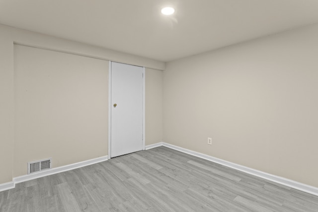 unfurnished bedroom with light wood-type flooring and a closet