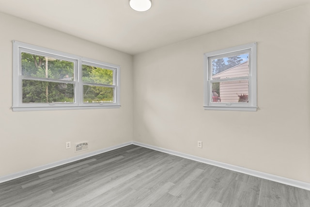 spare room with hardwood / wood-style flooring