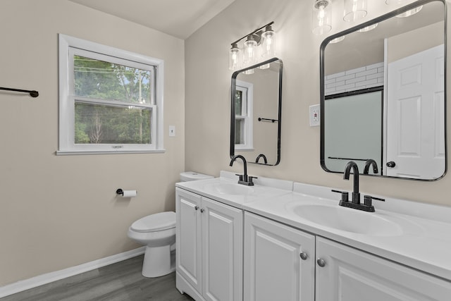 bathroom with a shower, wood-type flooring, toilet, and vanity