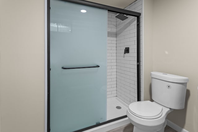 bathroom with toilet and walk in shower