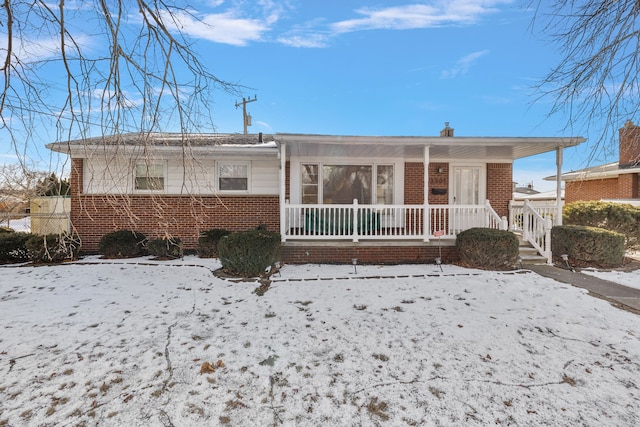 snow covered property featuring a porch