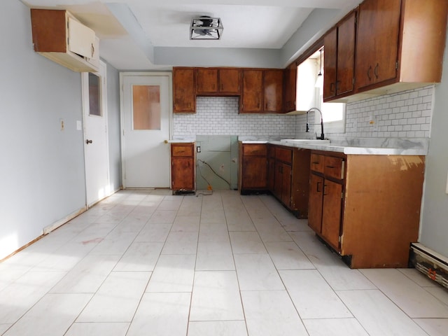 kitchen with tasteful backsplash, sink, and light tile patterned floors