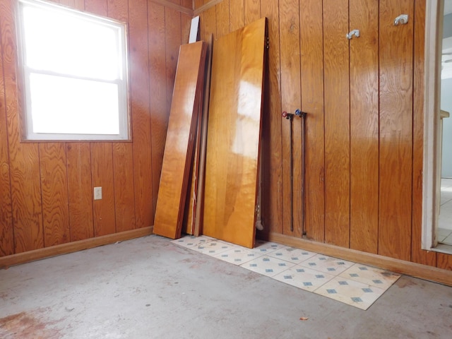 unfurnished bedroom featuring wood walls