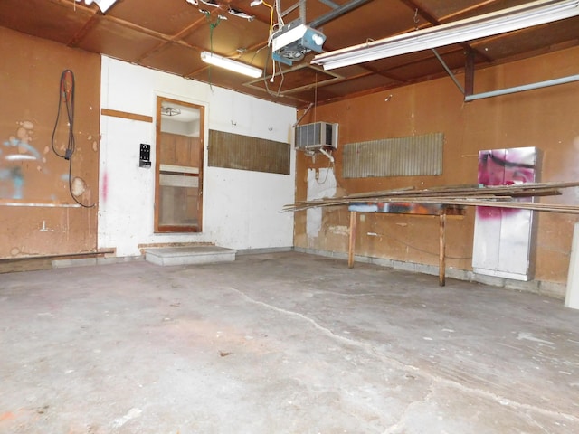 garage with a garage door opener and a wall unit AC