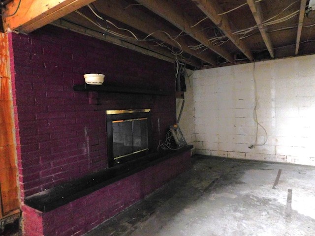 basement featuring a brick fireplace