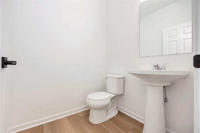 11964 Timber Ct, Bruce, MI 48065 - bathroom with baseboards, toilet, and wood finished floors