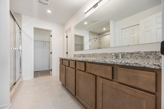 11964 Timber Ct, Bruce, MI 48065 - bathroom with vanity, visible vents, baseboards, a spacious closet, and a stall shower