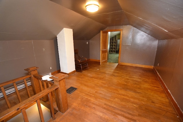 bonus room featuring hardwood / wood-style flooring and vaulted ceiling