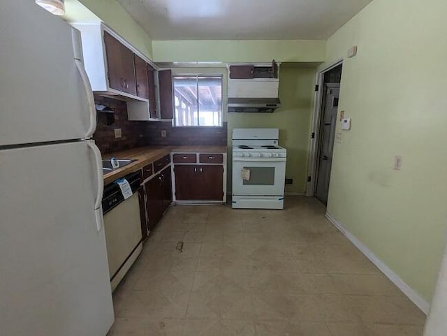 kitchen with dark brown cabinets, white appliances, and tasteful backsplash