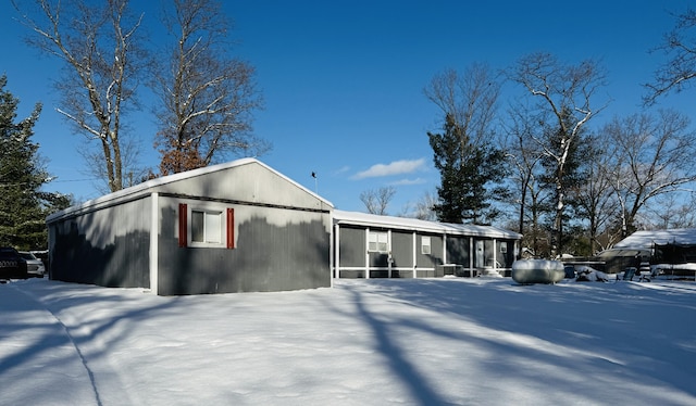 view of snow covered rear of property