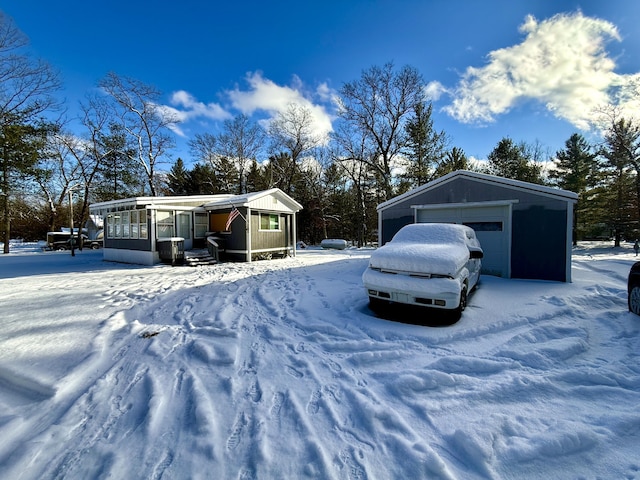 snow covered property with a garage