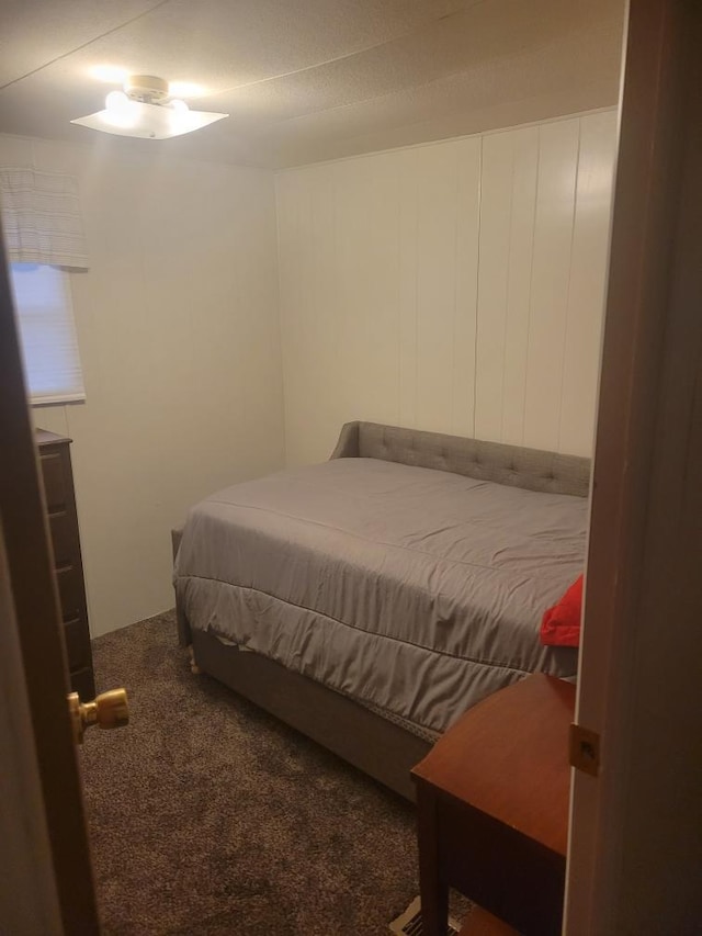 bedroom with dark colored carpet