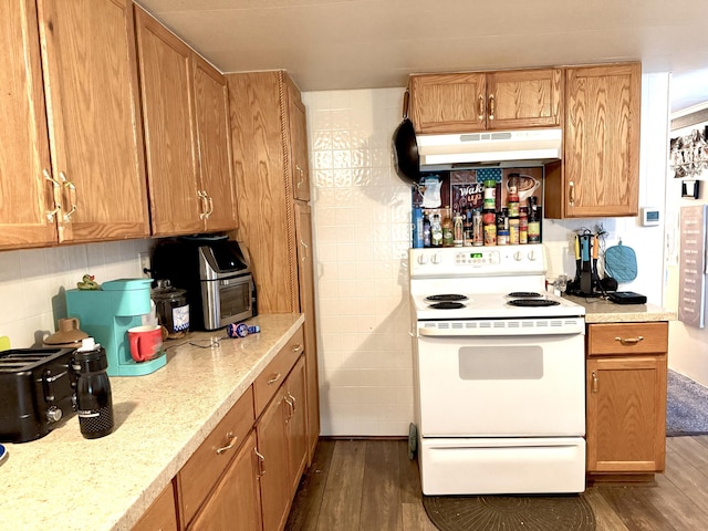 kitchen with dark hardwood / wood-style flooring and white range with electric cooktop