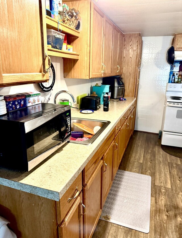 kitchen featuring dark wood-type flooring and electric stove