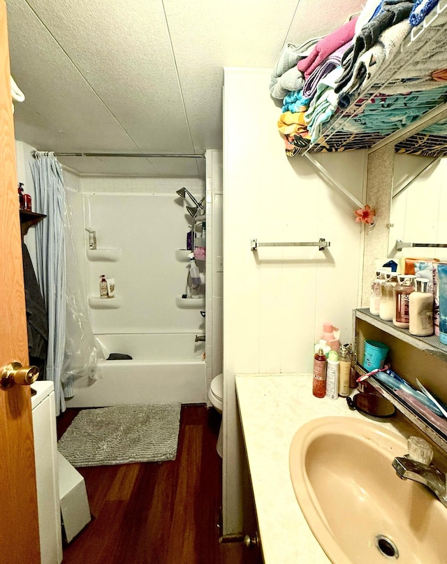 full bathroom with hardwood / wood-style floors, toilet, shower / bath combination with curtain, and vanity