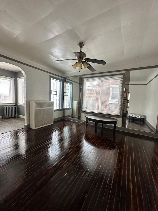 interior space featuring hardwood / wood-style flooring, radiator heating unit, and ceiling fan