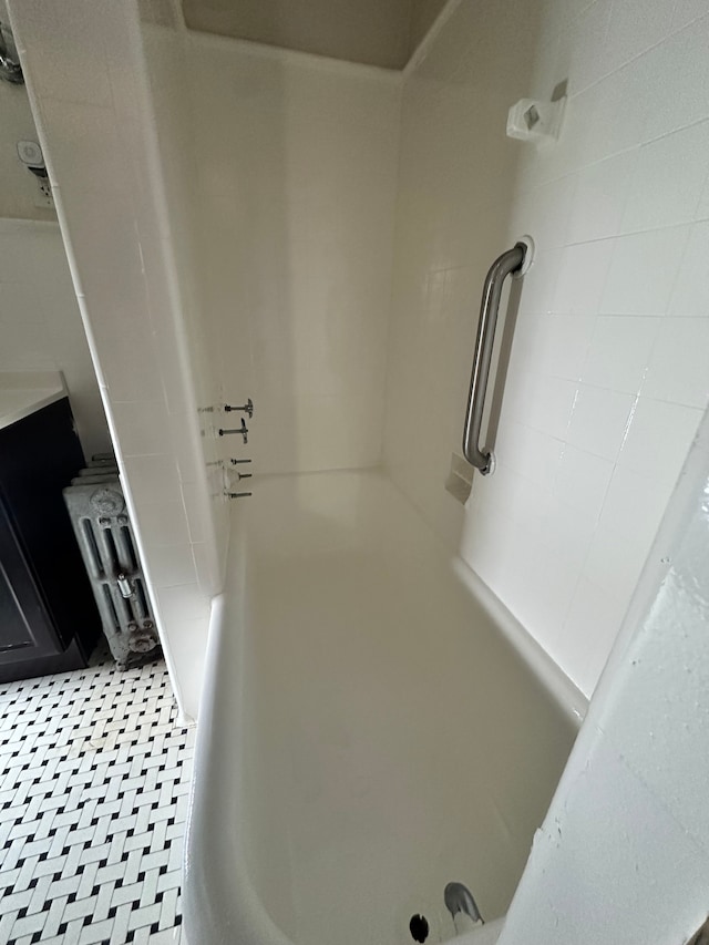 interior details featuring washtub / shower combination