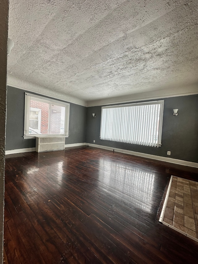 spare room featuring dark wood-type flooring